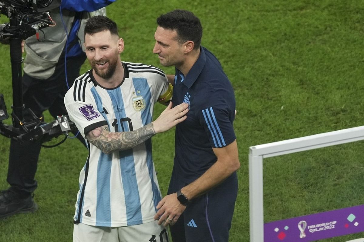Lionel Messi (L) of Argentina celebrates with head coach Lionel Scaloni after winning the semifinal 