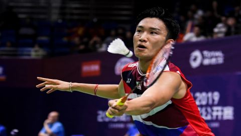 Japan's Kento Momota returns a shuttlecock to Indonesia's Tomm