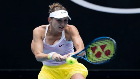 Belinda Bencic of Switzerland hits a return to Jelena Ostapenko