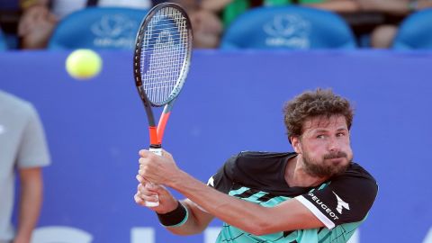 Robin Haase of the Netherlands returns the shot to Andrey Rublev of 