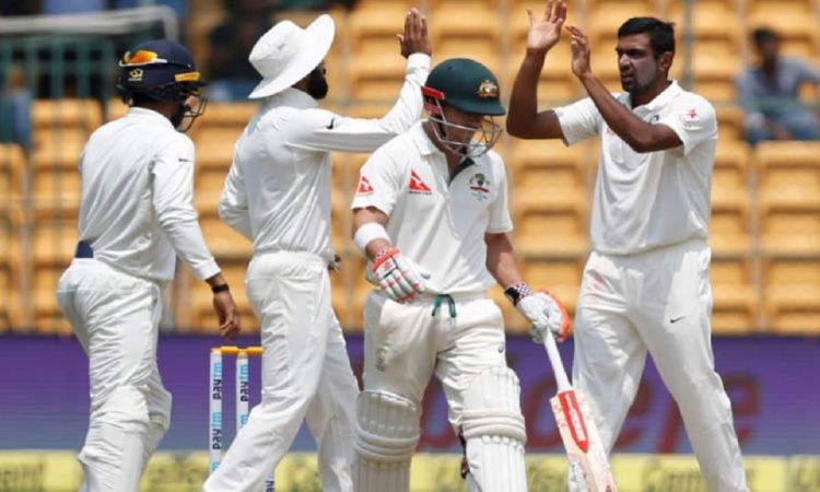 Bengaluru: Ravichandran Ashwin and Cheteshwar Pujara celebrate fall of David Warner's wicket during 