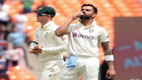 Ahmedabad : India's Virat Kohli kisses the locket as he celebrates his century during the fourth day