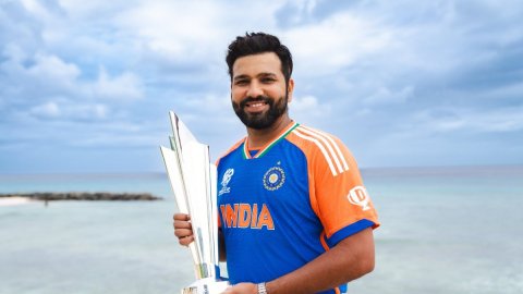 India's captain Rohit Sharma poses for photo with the winners' trophy after India won the ICC Men's 