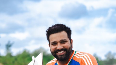 India's captain Rohit Sharma poses for photo with the winners' trophy after India won the ICC Men's 