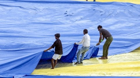 Kanpur: Groundsmen pull covers onto the field ahead of the second Test cricket match between India a