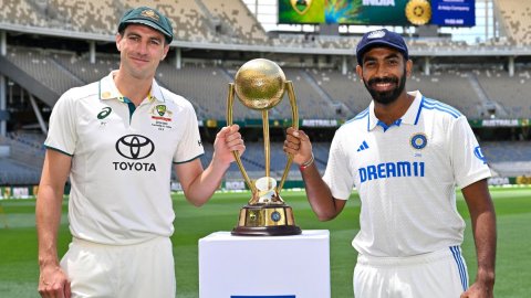 Perth: Australia's captain Pat Cummins and India's captain Jasprit Bumrah pose with the trophy 