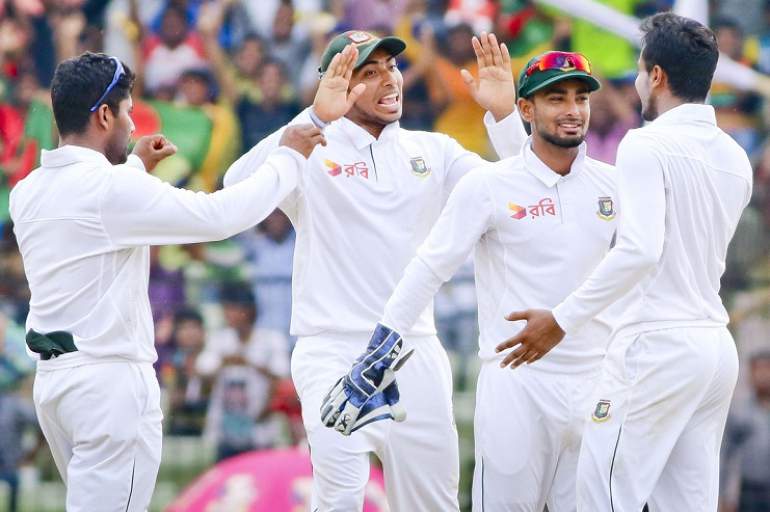 Bangladesh players celebrate fall of a wicket