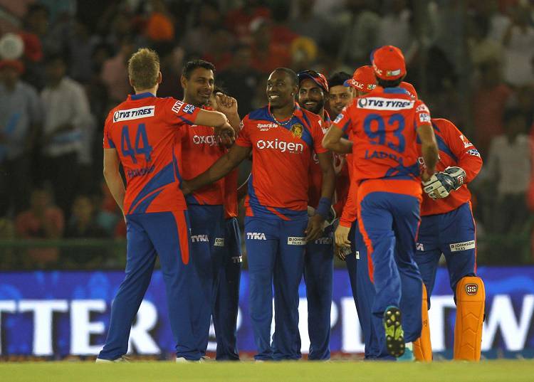 Gujarat Lions bowler Dwayne Bravo celebrates fall of a wicket in Tamil