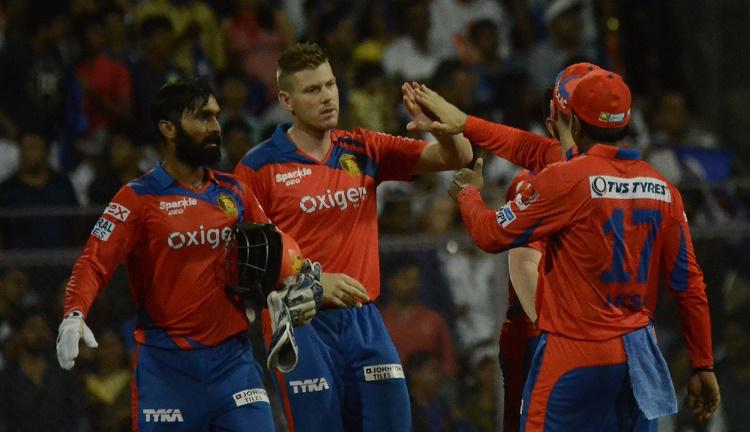 Gujarat Lions players celebrate fall of a wicket