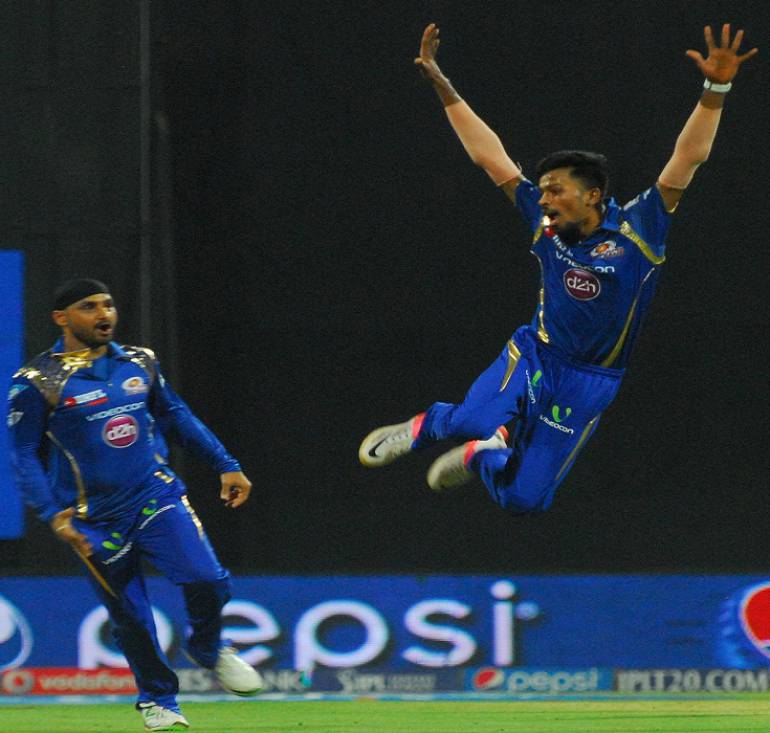 Mumbai Indians celebrate fall of a wicket in Tamil