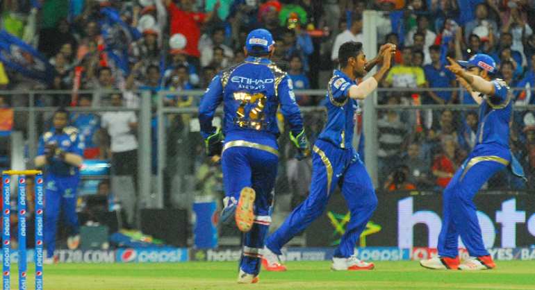 Mumbai Indians celebrate fall of a wicket in Tamil