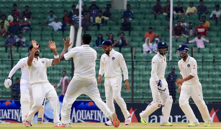 Indian players celebrate fall of a wicket