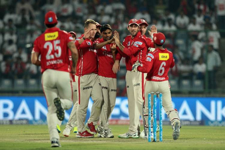 Kings XI Punjab players celebrate fall of a wicket  in Tamil