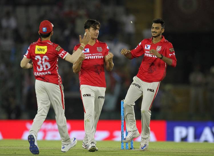 Kings XI Punjab players celebrate fall of a wicket in Tamil