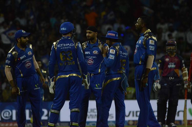 Mumbai Indians players celebrate fall of a wicket 