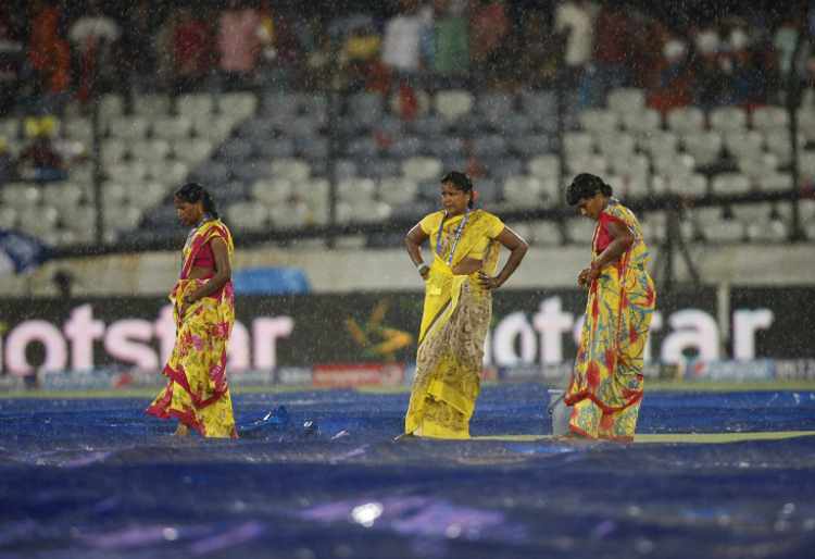 Ground staff at work during rain in Tamil