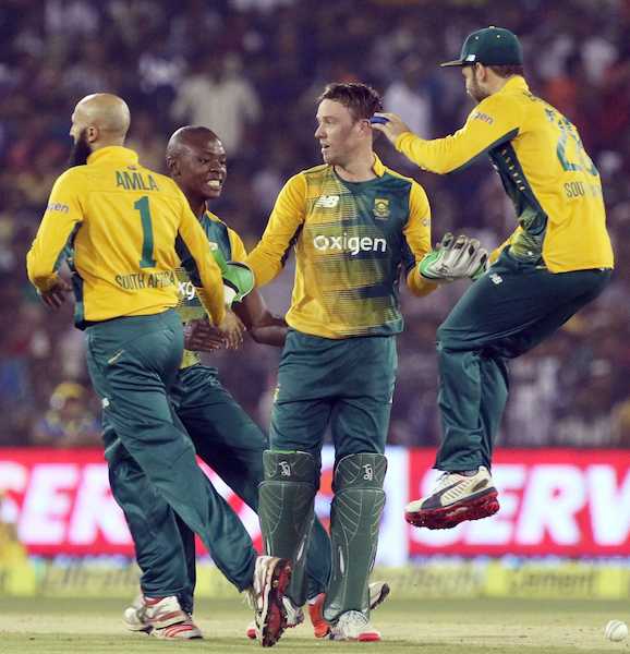 South African cricketers celebrate fall of a wicke