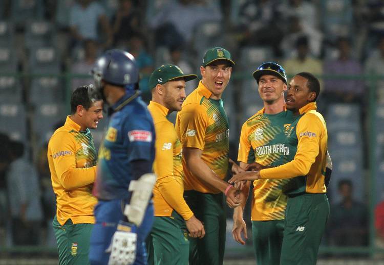 South African players celebrate fall of a wicket  in Tamil