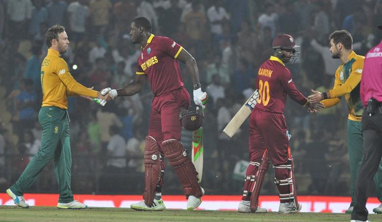 West Indies batsmen Carlos Brathwaite and Denesh Ramdin celebrate after winning the WT20 match again