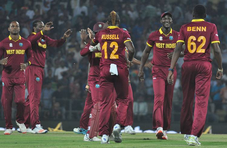 West Indies players celebrate fall of a wicket in Tamil