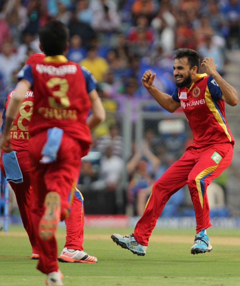 Royal Challengers Bangalore celebrate fall of a wicket  in Tamil